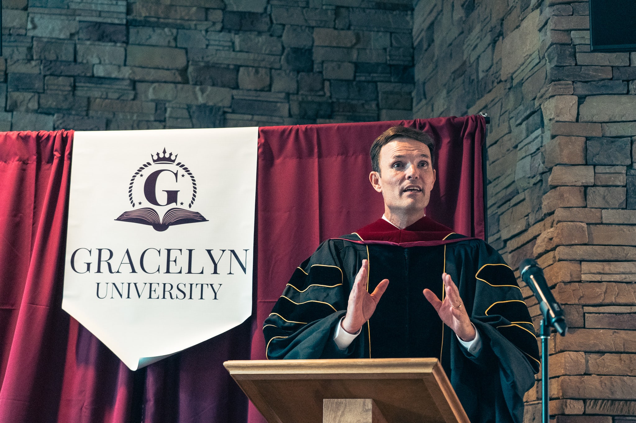 Dr. Matthew Flippen, founder and president of Gracelyn University, speaking at a podium