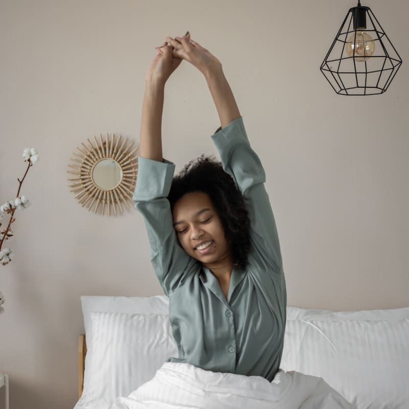 Woman stretching after waking up — Energy Boost IV therapy