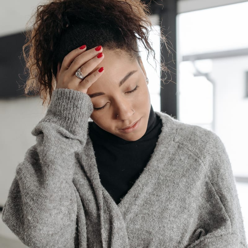 Woman holding head in pain — Immunity Boost PLUS IV therapy