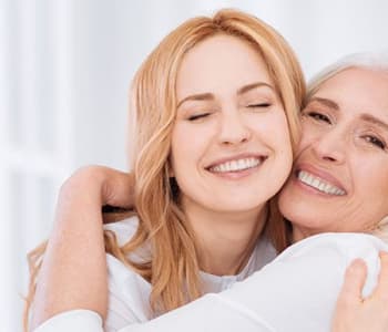 Une femme et sa mère se prennet dans les bras