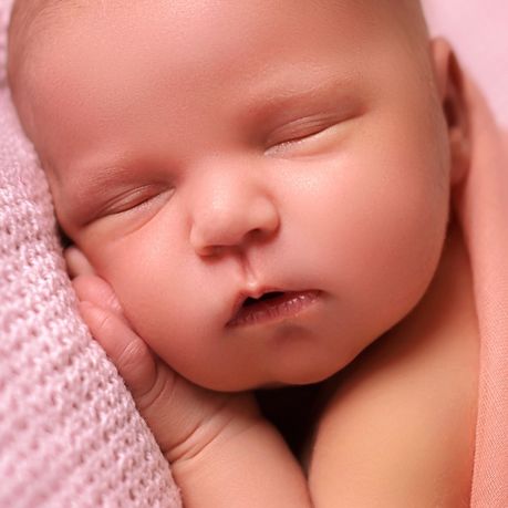 bebe qui dort la main sous sa tete