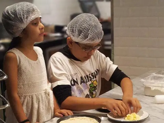 Teen cooking in the kitchen, trying a new recipe