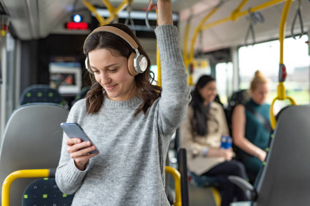 Student listening to podcast on bus commute