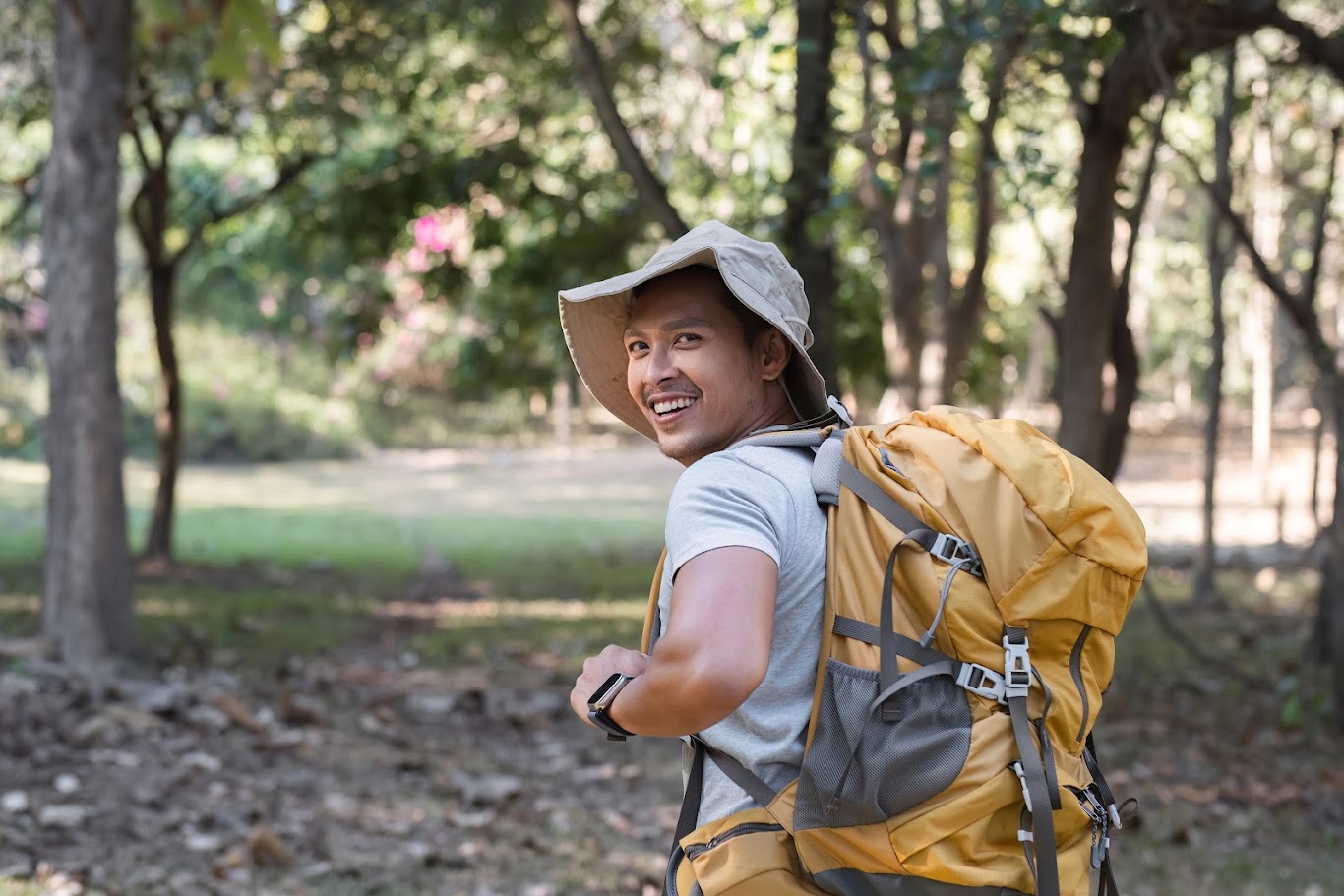 Backpacker planning a budget trip with a map and a small budget