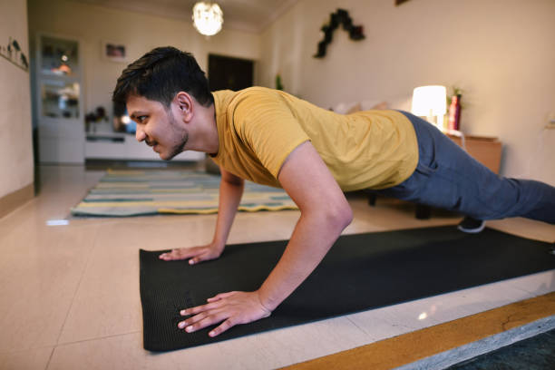 Person doing push-ups on a yoga mat at home