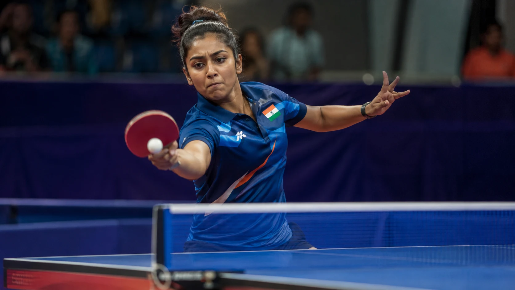 Table tennis player executing a forehand drive at competition level