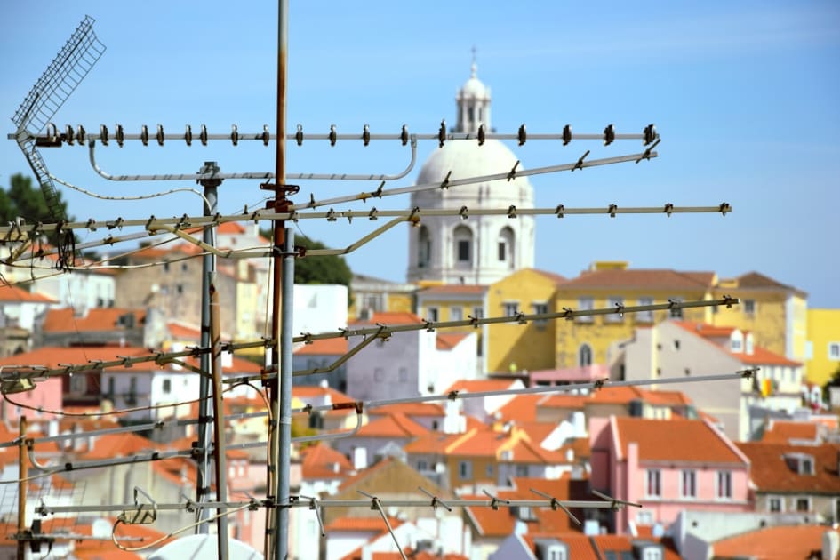 a view of a city with a church tower in the background