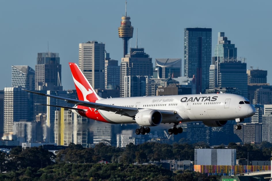 A large passenger jet flying over a city