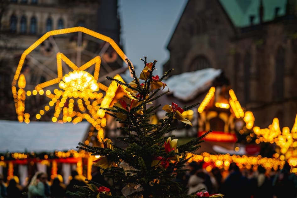 A christmas tree with a ferris wheel in the background
