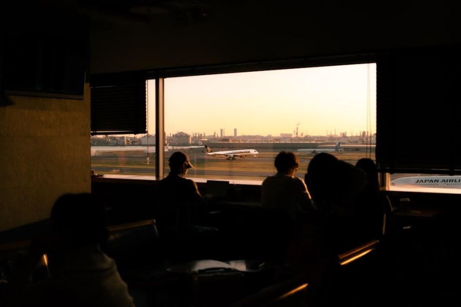 A group of people sitting in front of a window