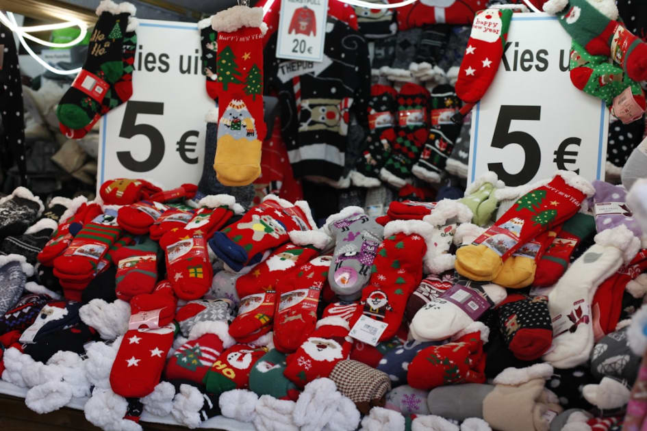 a pile of christmas socks for sale in a store
