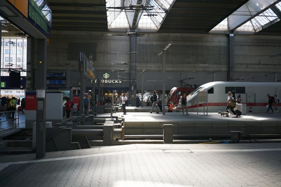 a train station with people and a train