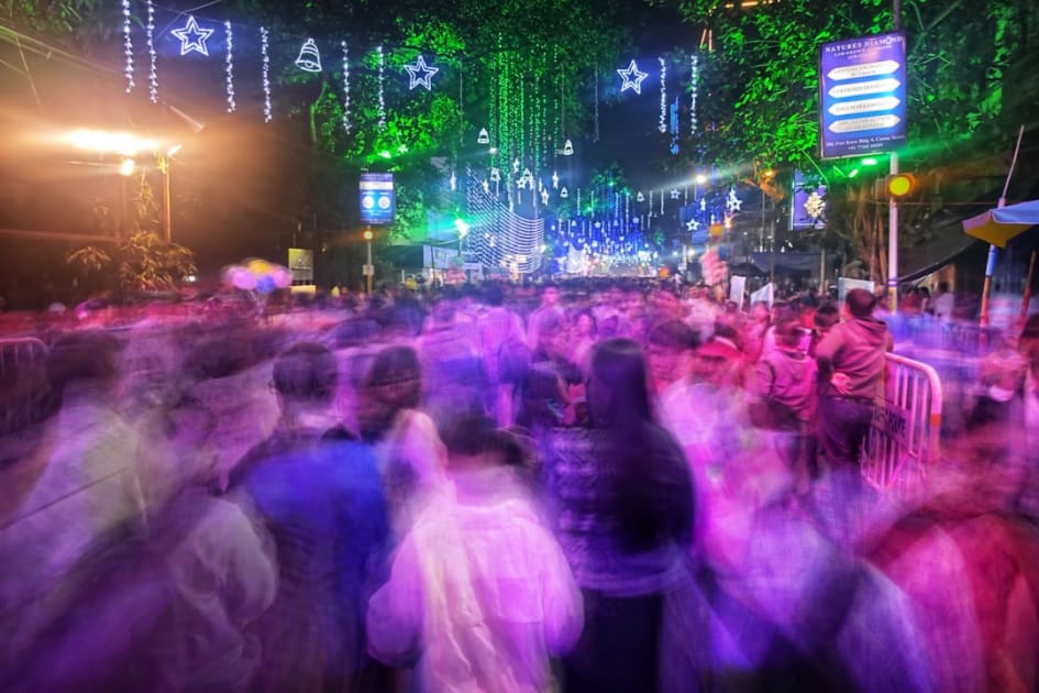 A large group of people are dancing in the street