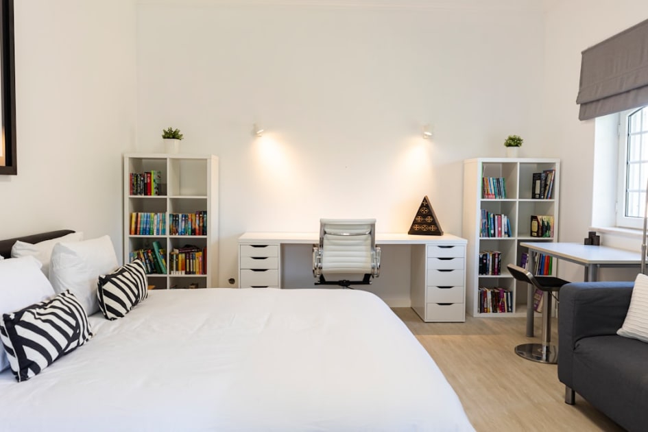 A cozy bedroom with a built-in workspace.