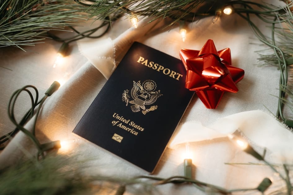 A passport with a red bow on top of it