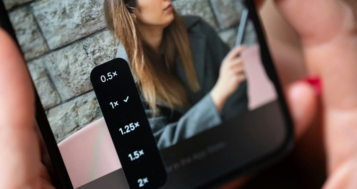 Hands holding smartphone displaying video editing zoom options