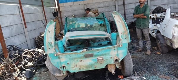 Tata Indica car getting scrapped in Bangalore by CarBasket - old vehicle dismantling, scrap car removal and recycling service