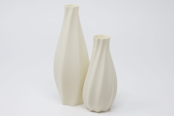 Two eggshell colored vases on a white background, one eight inches tall, the other six inches tall.