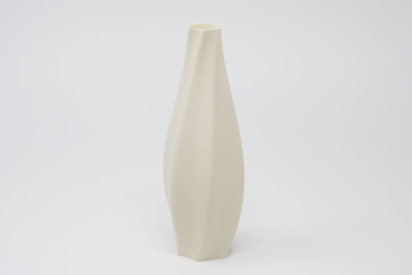 Twisting eggshell colored vase on a white background.