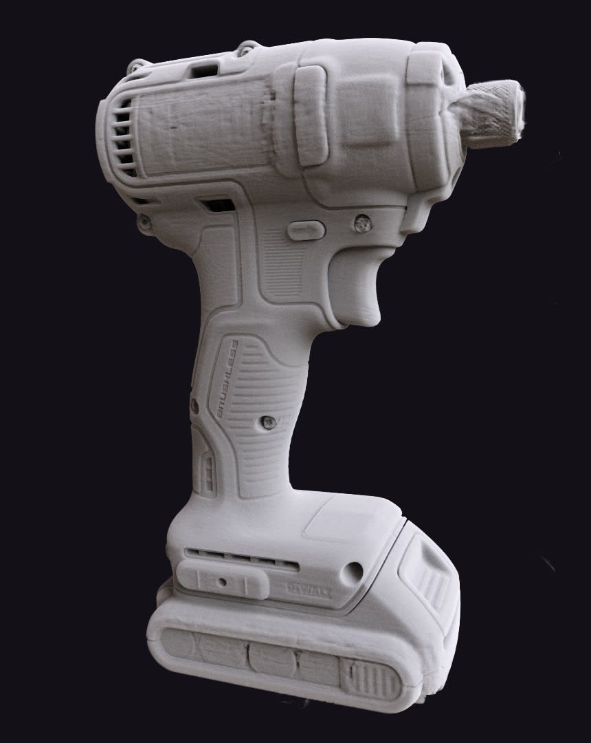 3D surface of the same cordless drill reconstructed with Voxray QRT's geometry correction, with vents, buttons and lettering on the housing