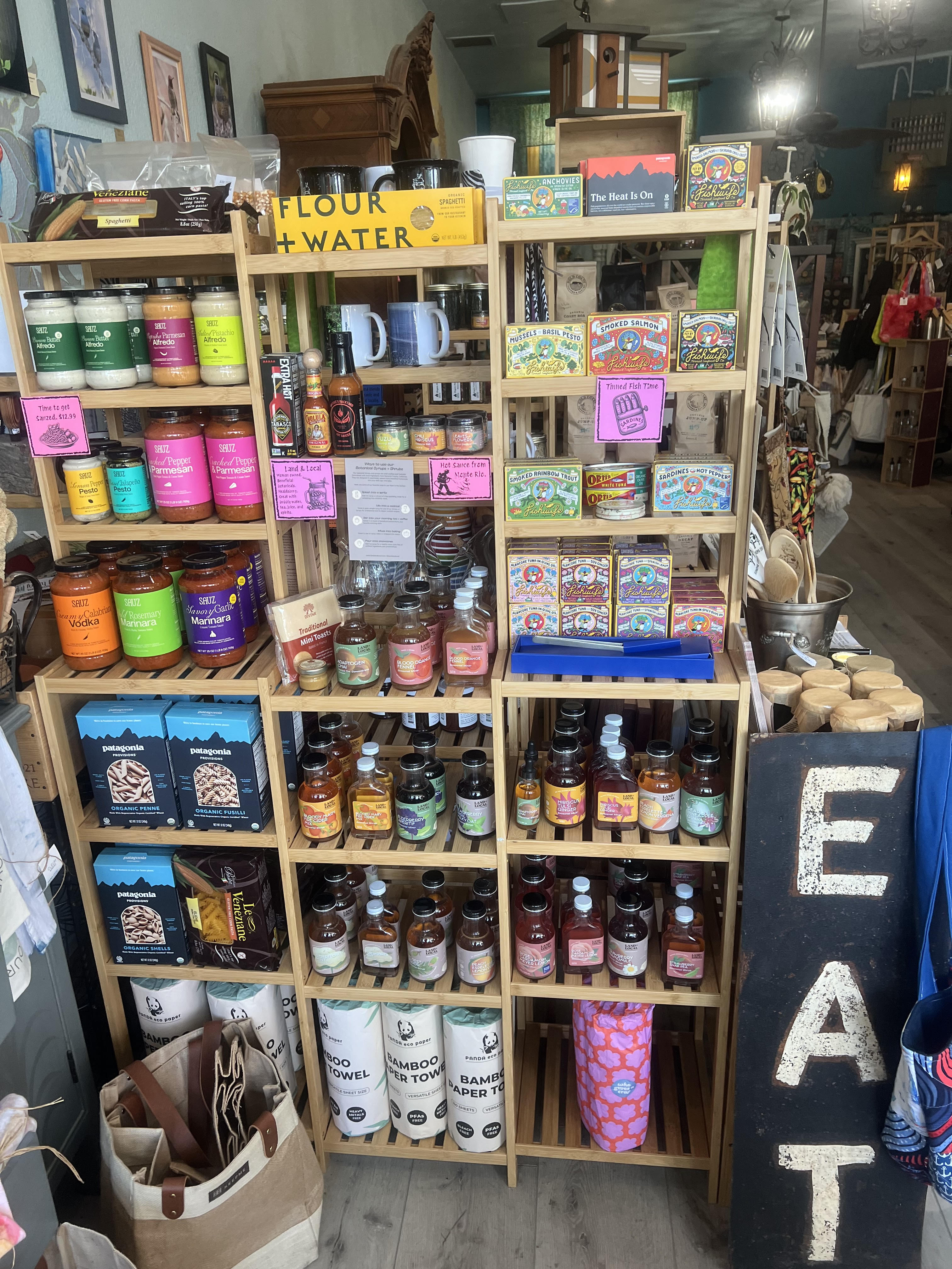 Pantry shelves at Local...ish stocked with tinned fish, botanical syrups, and artisan goods