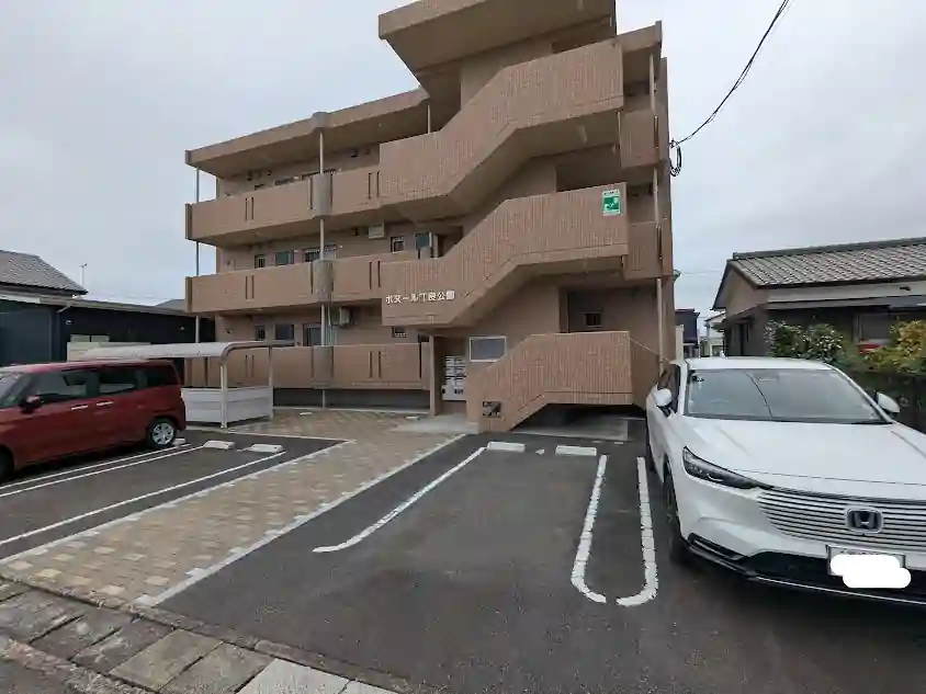 日向市江良町にある賃貸マンション「ポヌール江良公園」の外観と駐車場
