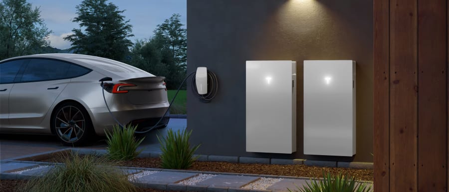 Modern home With Solar Panels and red Model S parked outside