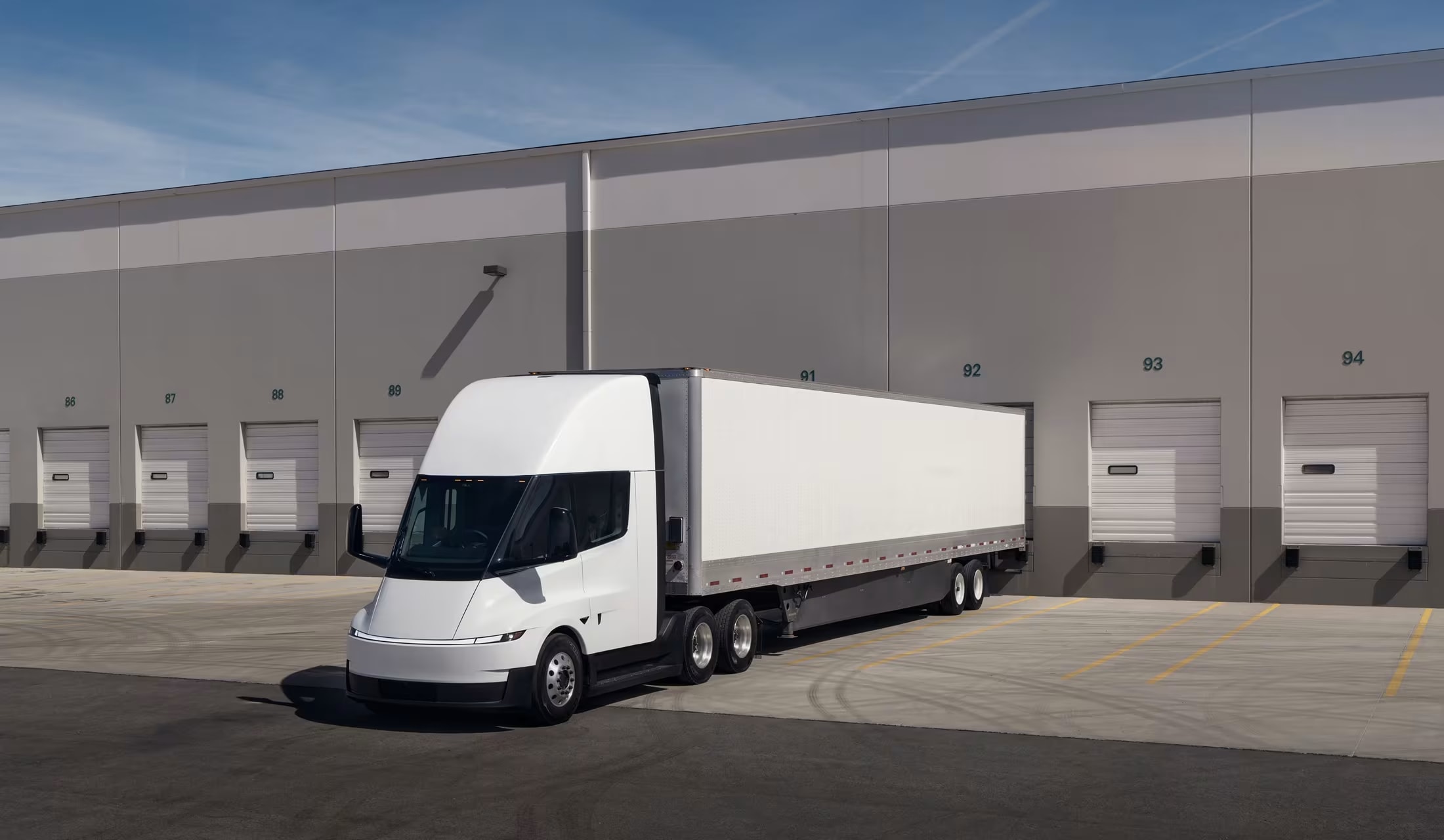 Electric Semi truck parked in front of a warehouse