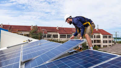 Solar panel roofer installing a new solar panel