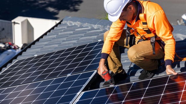 solar panel roofer on a roof installing solar panels