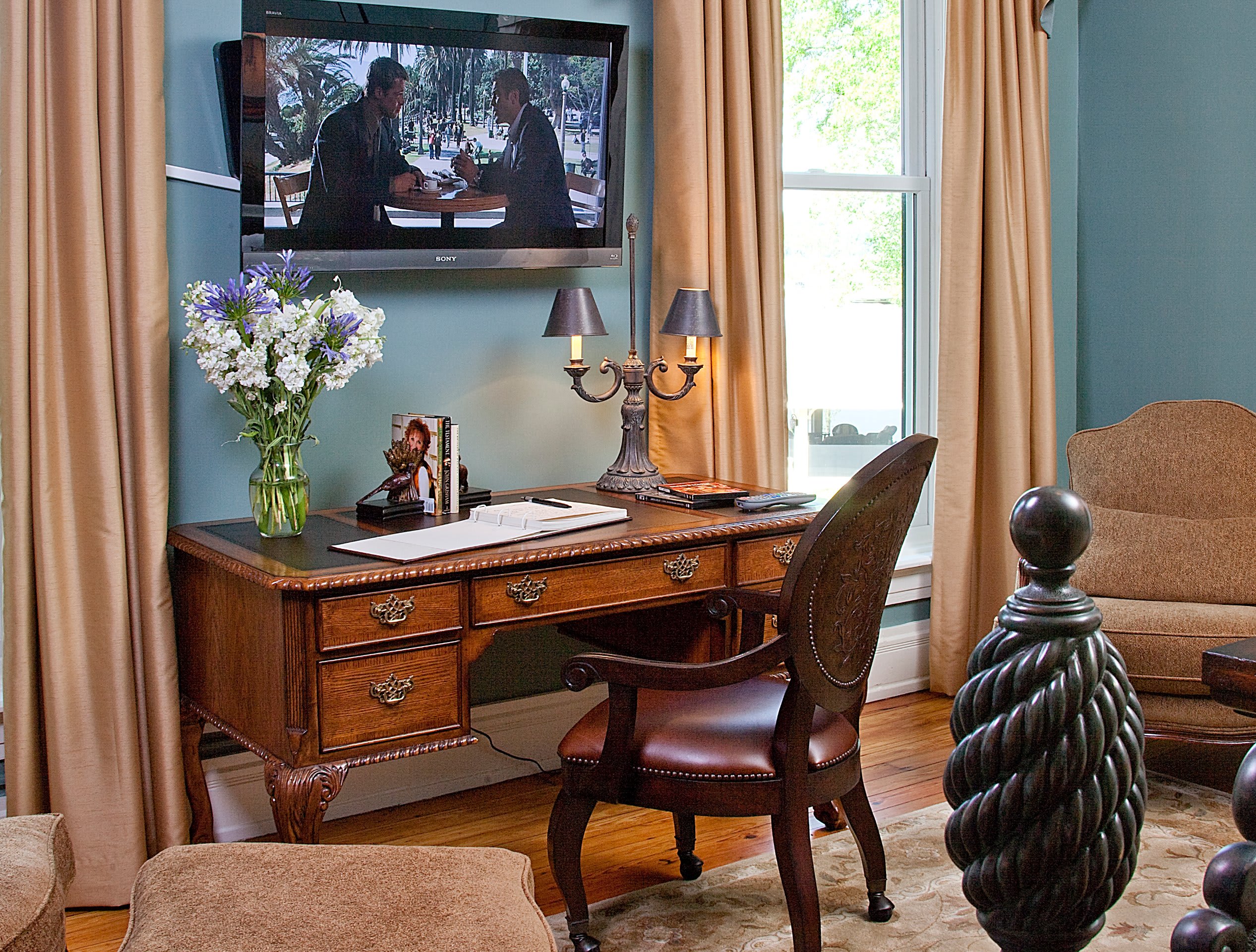 Tulip Suite bedroom with antique furnishings and soft blue walls