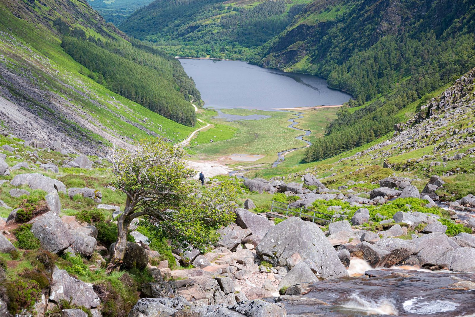 View from the Spinc over the Glenealo Valley with Upper Lake and hiker on the rocky path