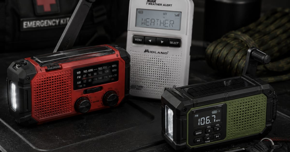 Hand crank NOAA weather radio and emergency radios on dark emergency kit surface