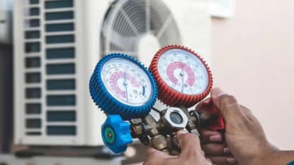 Man checking Air Conditioner Using Pressure Testing Meters