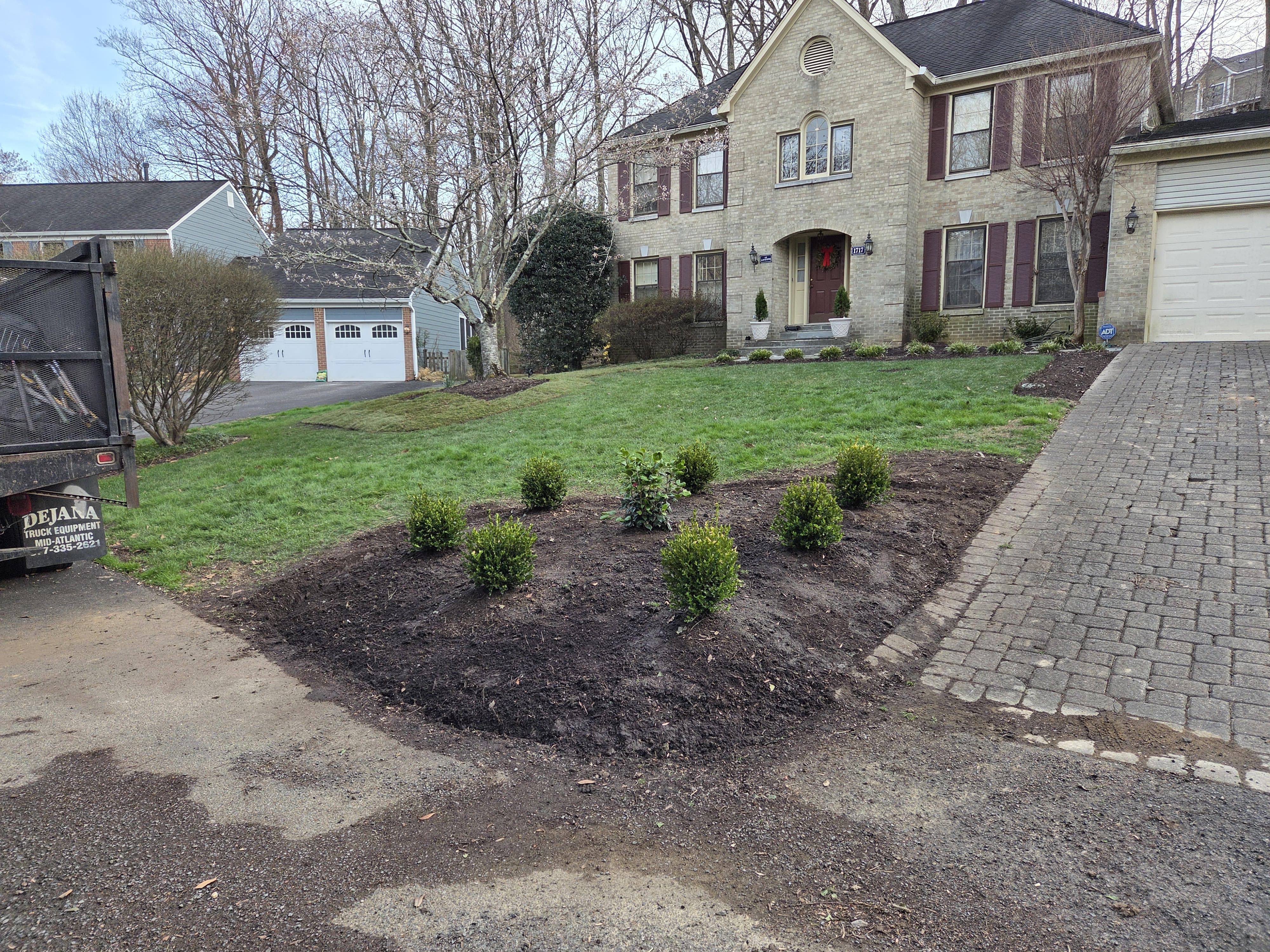 Finished landscaping with trimmed lawn and shaped beds