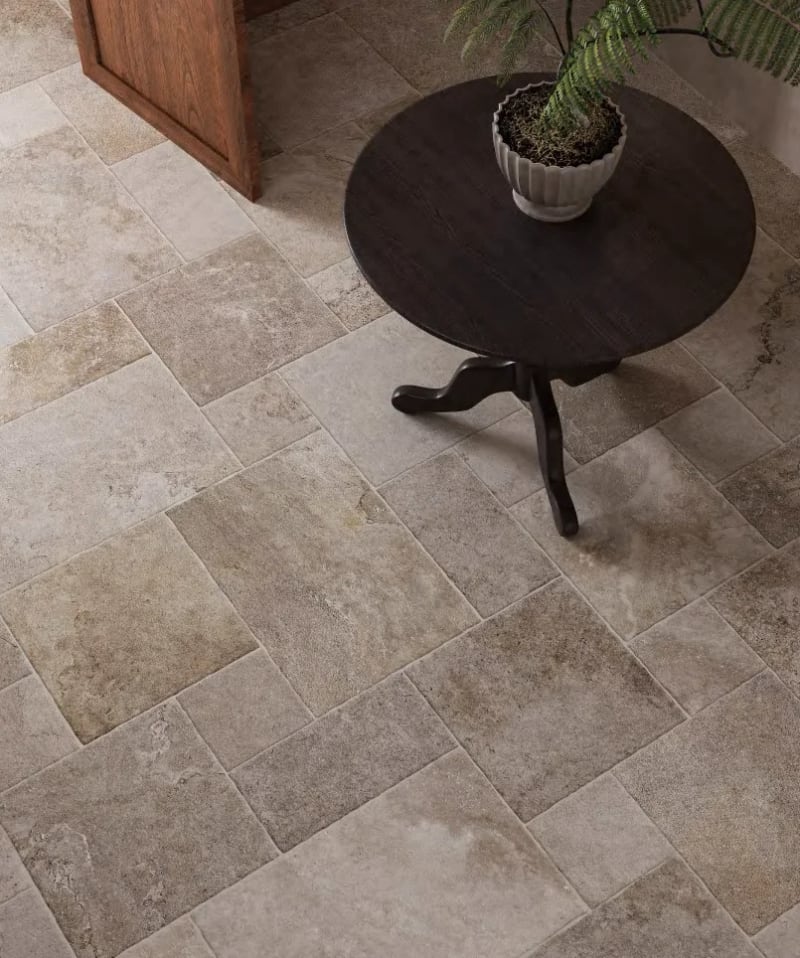 Concord French pattern porcelain in a warm earth tone, laid as modular stone-look paving in an Australian courtyard.