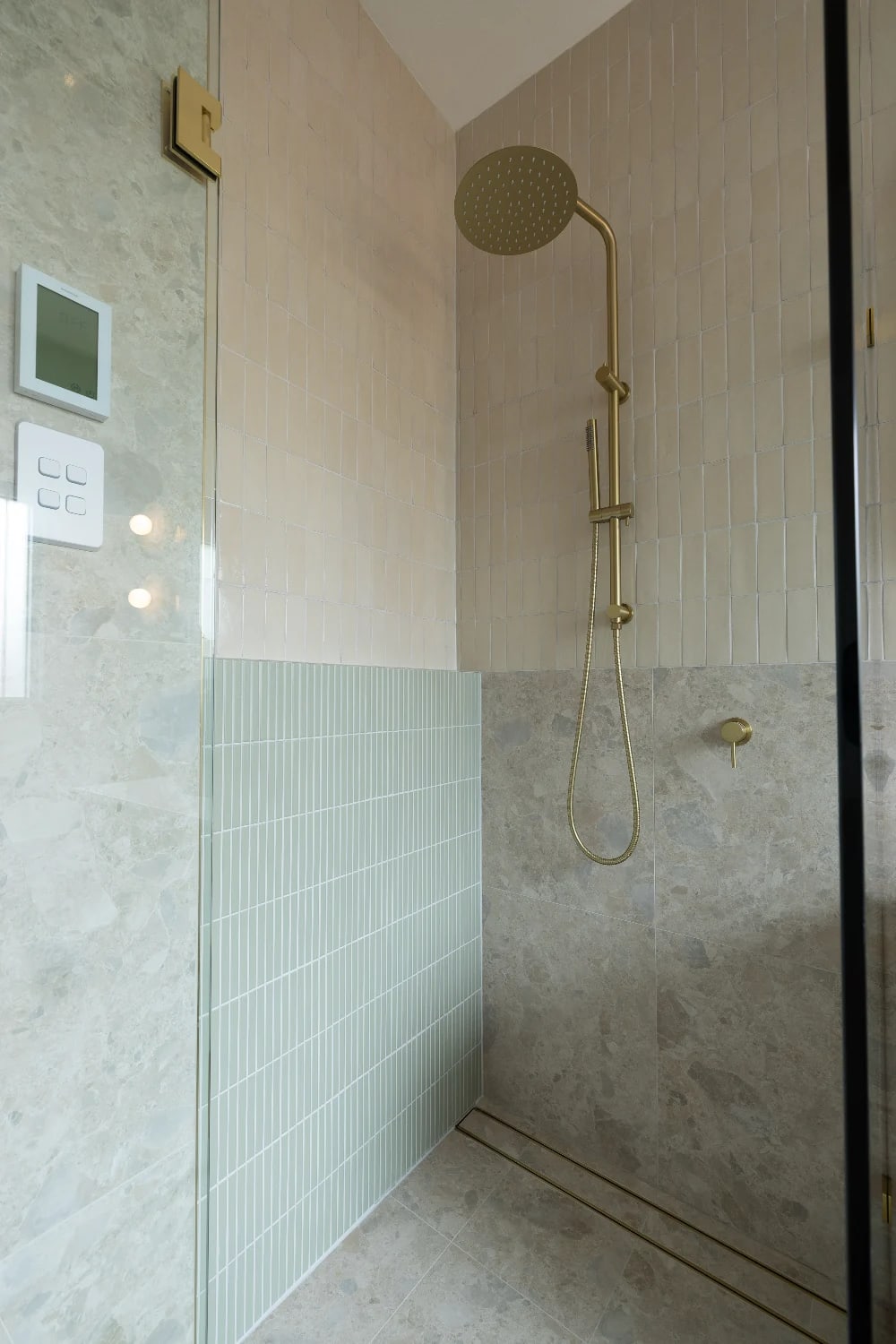 Shower head detail - brushed brass meets Kit Kat Sage and Zellige Natural at the corner.