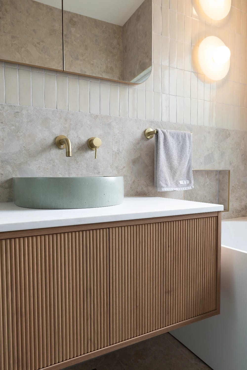 Vanity close - mint basin, brushed brass tap, Norrock Ivory's soft tonal variation just behind.