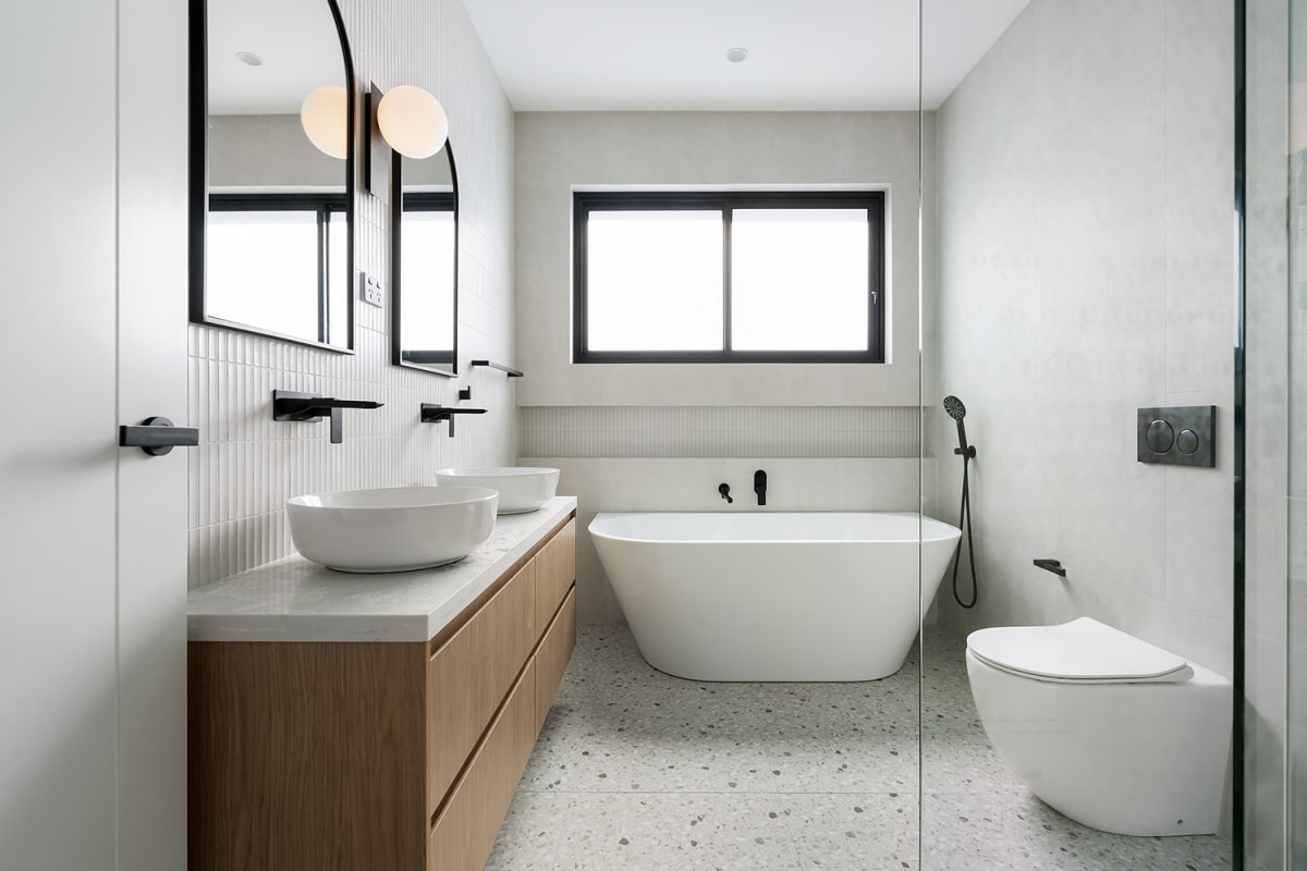 Contemporary Sydney bathroom with twin basins, terrazzo floor, kit-kat feature wall and large-format stone-look porcelain.