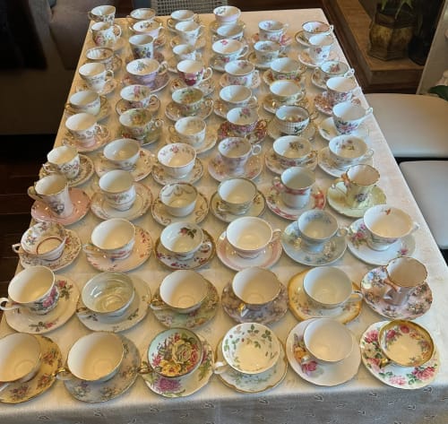 Vintage tea service arranged on a bridal shower table.