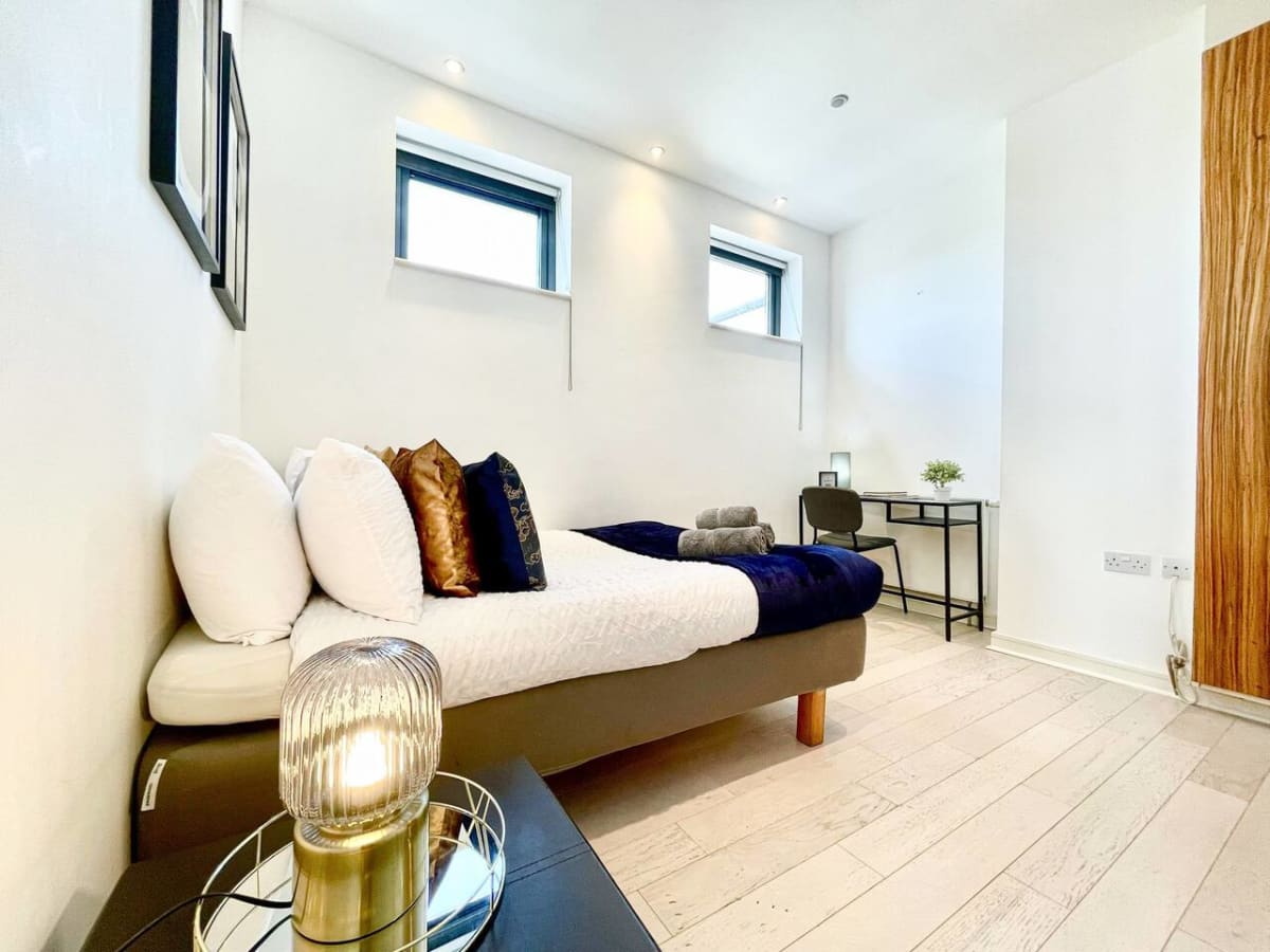 Double bedroom with a desk by the window at the Pentonville Road apartment