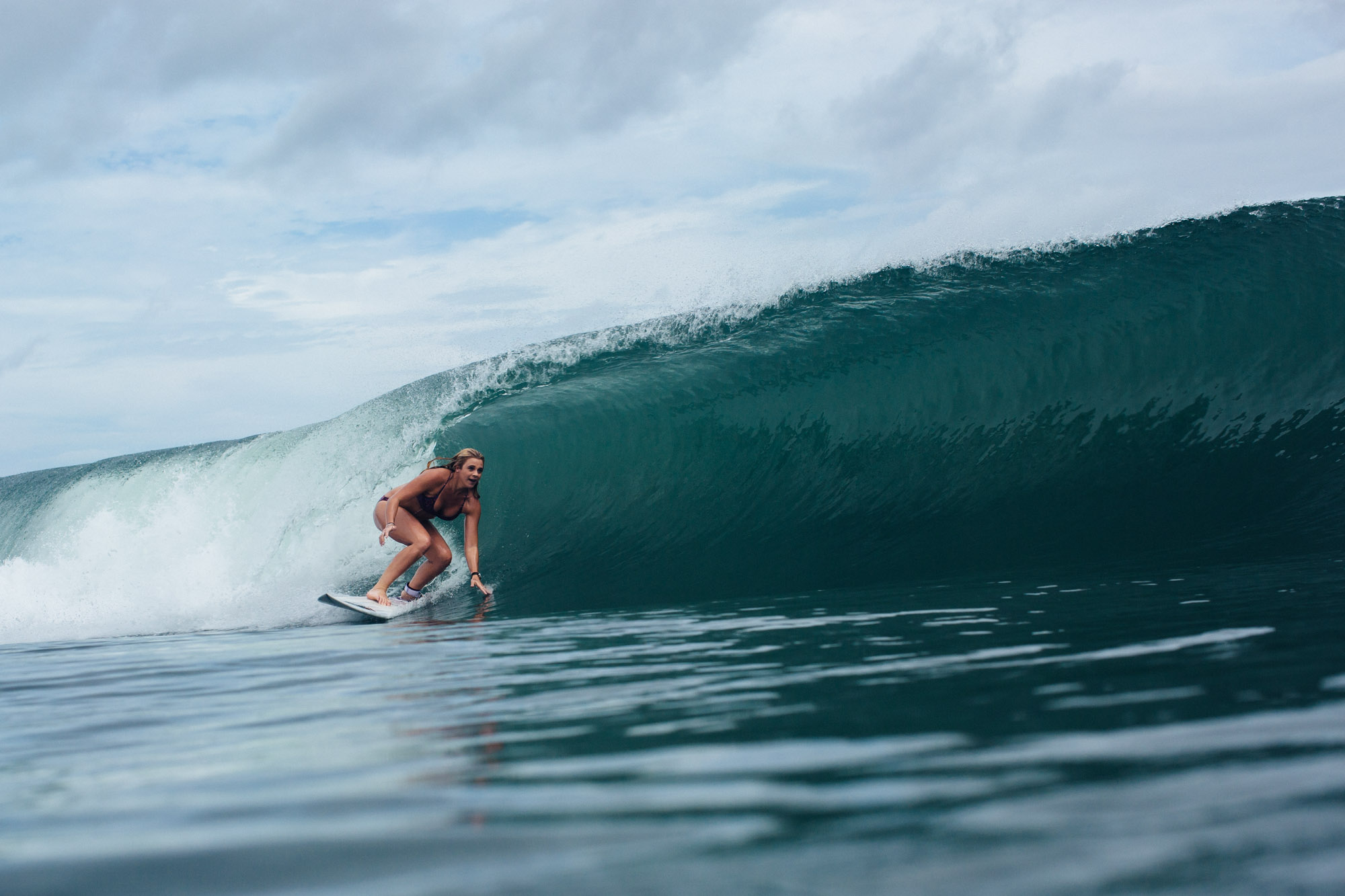 Surfer riding a clean wave at Playa Maderas near San Juan del Sur, Nicaragua