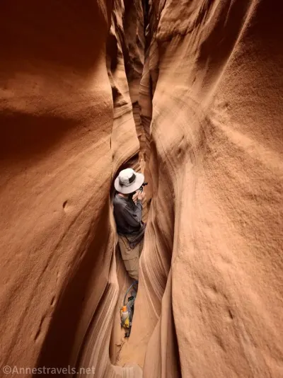 A hiker in a very, very narrow slot canyon 