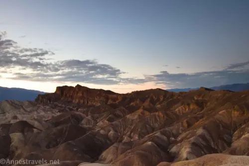 Dusky striped badlands under sunset skies at Zabriskie Point in Death Valley National Park
