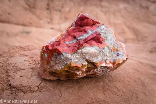 A rock with a red center surrounded by white rock and orange rock on the outside