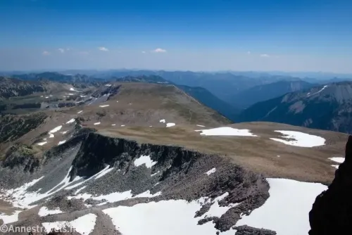 the flatland between Second and Third Burroughs Mountain streaked with snow and with cliffs on the edge in Mount Rainier National Park 