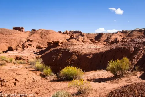 Red badlands with yellow buses in the foreground
