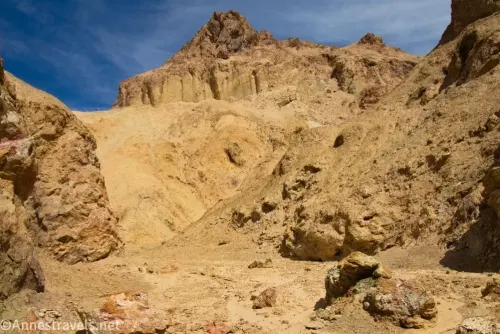 Rock formations above a yellow desert canyon