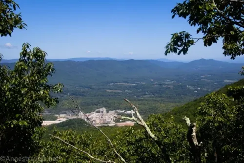 Views across a cement plant to green mountains