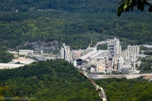 Cement factory surrounded by green trees below the Tinker Cliffs